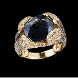 A ring800/000 gold, set with oval cut diamond (ca.7.00ct) and various small sapphires and round