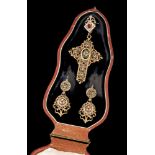 A cross pendant and earringsGilt metal. Mid 19th c. inspired pierced and scalloped design, decorated