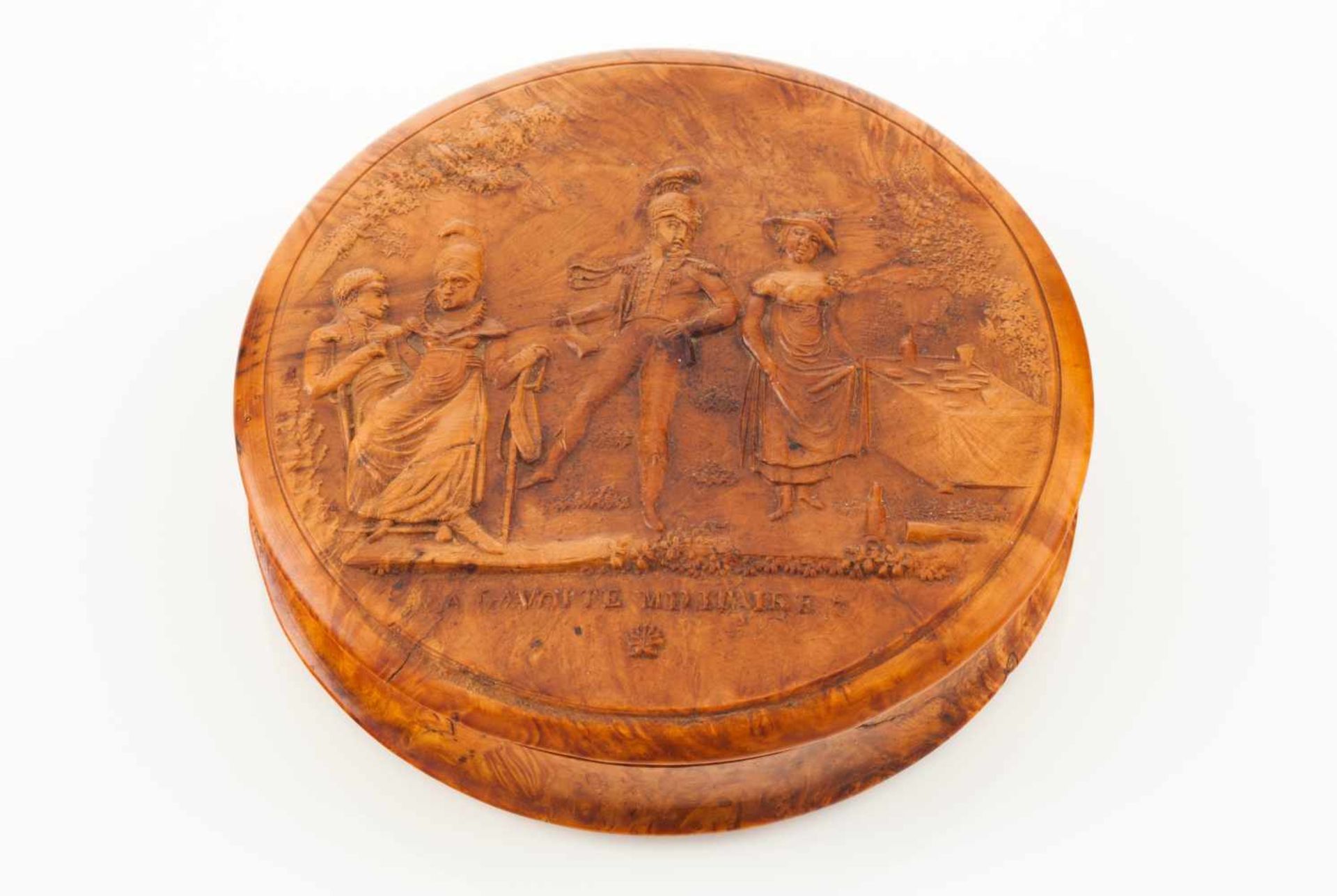 A lided boxBurr walnutCarved decoration depicting an open air scene with servicemen and female