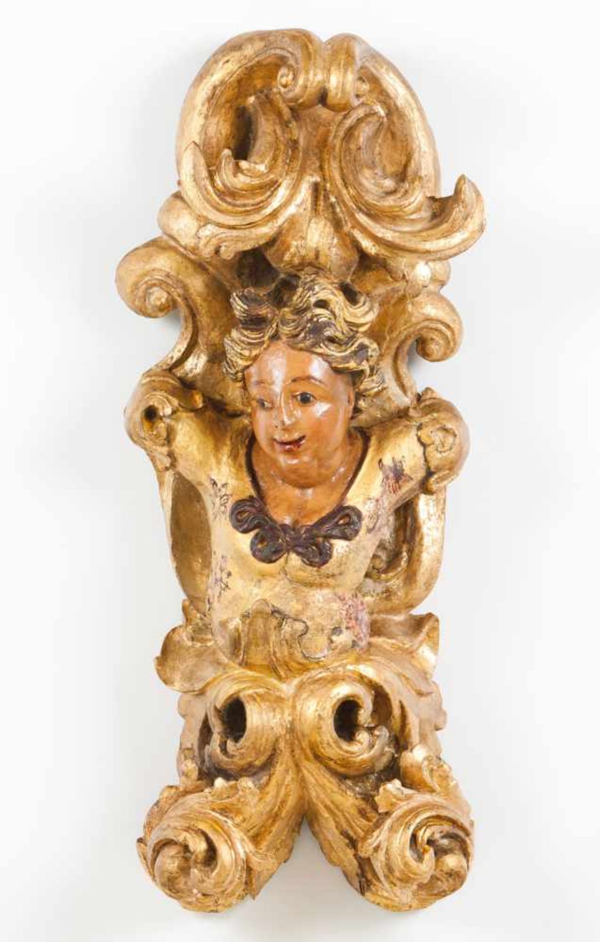 An altar fragmentCarved, gilt and polychrome wood depicting a male torso and foliage scroll