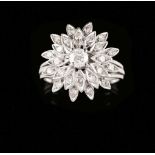 A ringLow purity goldTriple band with flower top; petals set with small 8/8 cut diamonds centred