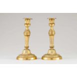 A pair of Louis XVI candle standsGilt bronzeMoulded and fluted decoration with floral and foliage