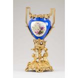 A Napoleon III urn Porcelain Polychrome and gilt floral decoration Putti and grape motifs to stand