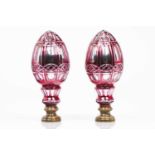 A pair of staircase finialsCut red and silvered blown glassYellow metal mountsHeight: 28,5 cm- - -