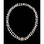 A pearl necklaceTwo baroque grey pearls strandsChained in goldGold clasp set with garnets, pearl and