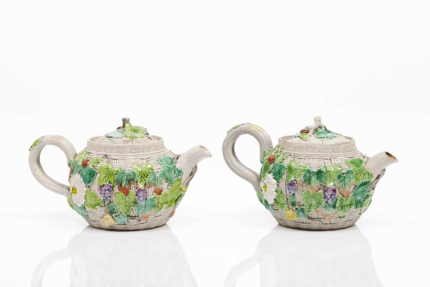 A pair of Yixing teapotsLight coloured clayRaised, simulated basket weave decoration with applied