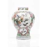 A potChinese porcelain "Famille Verte" enamelled decoration with cartouches of landscapes, flowering