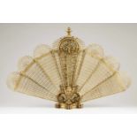 A Napoleon III fan fire screenRaised bronze and pierced metal sheetFrance, 19th centuryHeight: 70