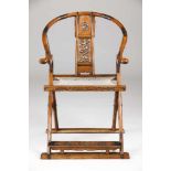 ​A folding chairHuanghualiHorse shoe shaped crest extending to form the armrestsCarved decoration