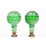 A pair of staircase finialsCut green and white blown glassYellow metal mountsHeight: 24 cm- - -15.00