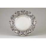 A salverPortuguese silverPlain chiselled border base and scalloped rim of profuse raised floral