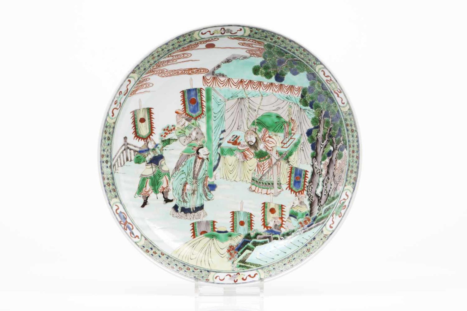 A large plateChinese porcelainWucai decoration of landscape with warriorsKangshi (1662-1722) mark of