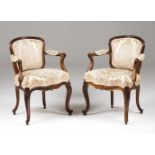 A pair of Louis XV style armchairs