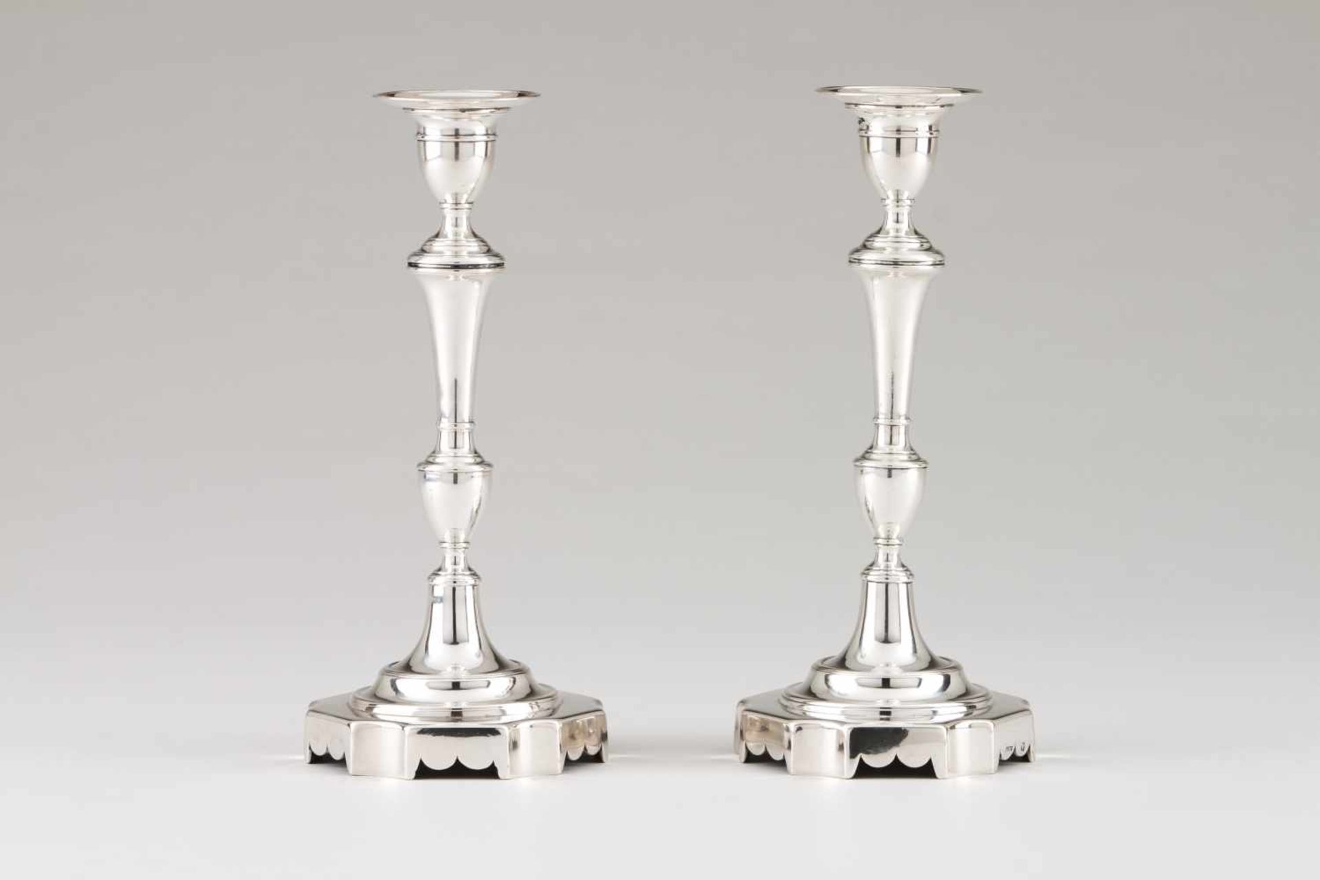 A pair of António Firmo da Costa candle stands<