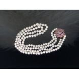 An ELEGANT Akoya Pearl Necklace with 9CT Gold Ruby and Sapphire Buckle