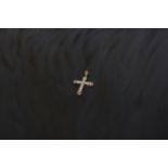 A 9ct gold cross pendant with diamond