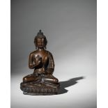 A BRONZE SEATED FIGURE OF BUDDHA SAKYAMUNI, TIBET, 18TH CENTURY