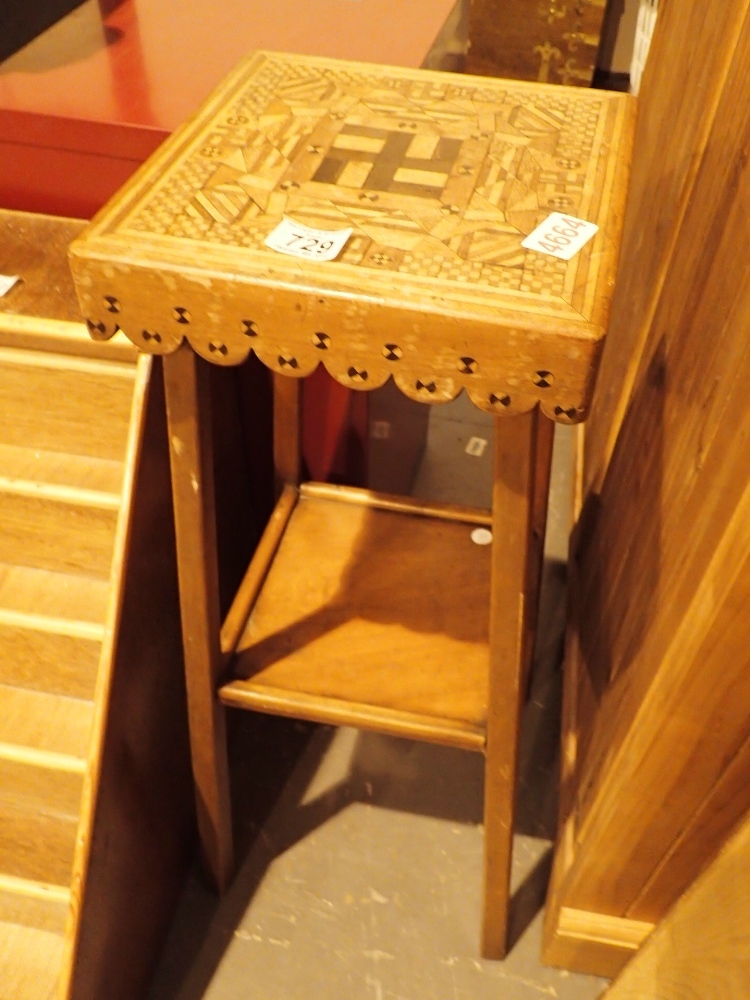 Inlaid table with reverse Swastika decor