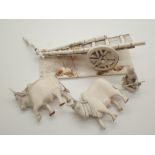 Damaged carved bone ox cart and driver
