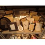 Shelf of empty easel picture frames with mainly wooden bodies