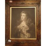 Antique oak picture frame with raised decorative border with black and white print of a young woman