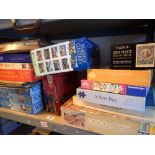 Shelf of jigsaw puzzles by Falcon Waddingtons and others from 1000 to 5000 pieces New York skyline