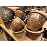 Eight earthenware planters with glazed exteriors various colours and designs