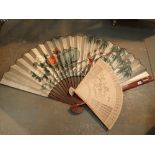 Large Chinese wooden carved fan and a further large Chinese paper painted fan