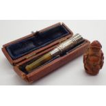 Silver and amber cased cigarette holder and a hand carved netsuke