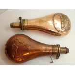 Two copper and brass powder flasks with hunting decoration