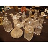 Nine glass decanters mainly crystal and a small claret jug