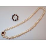 Cased set of real pearls with 9ct gold clasp and a gold garnet and pearl brooch