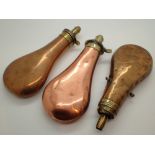 Three plain antique copper and brass powder flasks