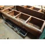 Very large glazed earthenware animal feeding trough with three feeding compartments and one with