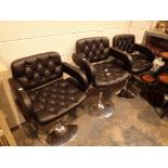 Three matching black buttoned upholstered barbers salon chairs with rise and fall seats