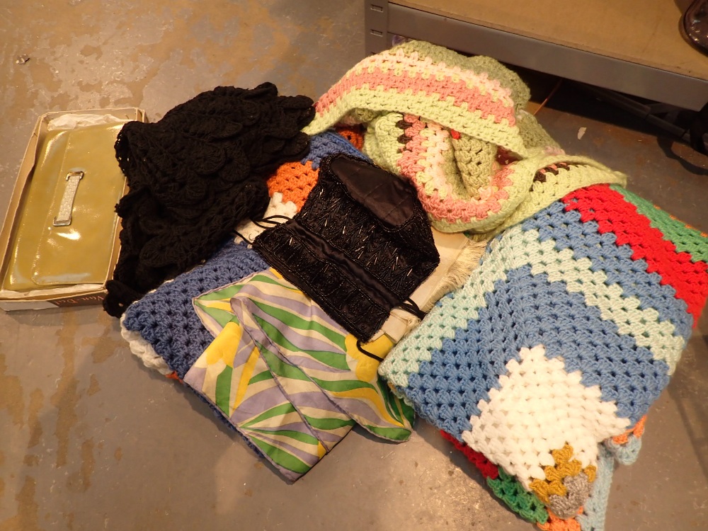 Box of mixed items including four small crochet blankets two silk scarves an evening bag and a