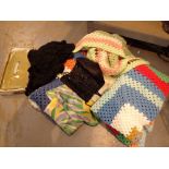 Box of mixed items including four small crochet blankets two silk scarves an evening bag and a