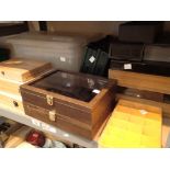 Shelf of assorted wood and plastic small storage and display boxes