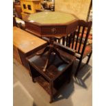 Octagonal mahogany side table with leather top and four drawers with lion claw feet and a table
