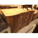 Light oak sideboard by Nathan with two side cupboards two lower drawers and a central drinks