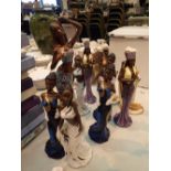 Ten figurines of African Native women in traditional dress hand painted