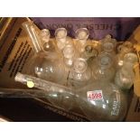 Shelf of chemistry bottles and flasks ( some named )