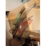 Kukri knife in decorated sheath with two Indian decorative swords