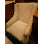 Contemporary upholstered chair with brass castors to front legs