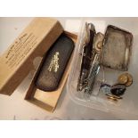 Box of mixed items including vintage spectacles silver spoons folding knives and a petrol lighter