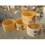 Set of four Luorine napkin rings three with hallmarked silver initial decoration