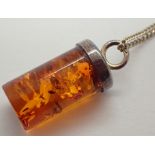 Silver amber pendant on silver necklace