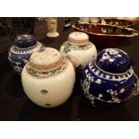 Four Oriental lidded ginger jars two hand painted and two blue and white Prunus pattern