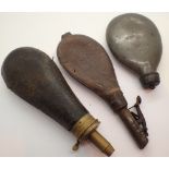 Three antique leather and brass powder flasks