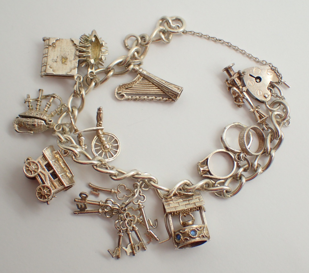 Sterling silver 1977 charm bracelet with assorted silver charms 48g